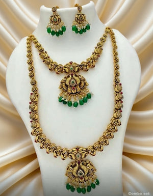 Gold necklace with green gemstones on a mannequin bust against a beige satin background